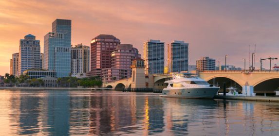 West Palm Beach, Florida, USA. Cityscape image of West Palm Beach, Florida with reflection of the city skyline in the water at beautiful sunset.